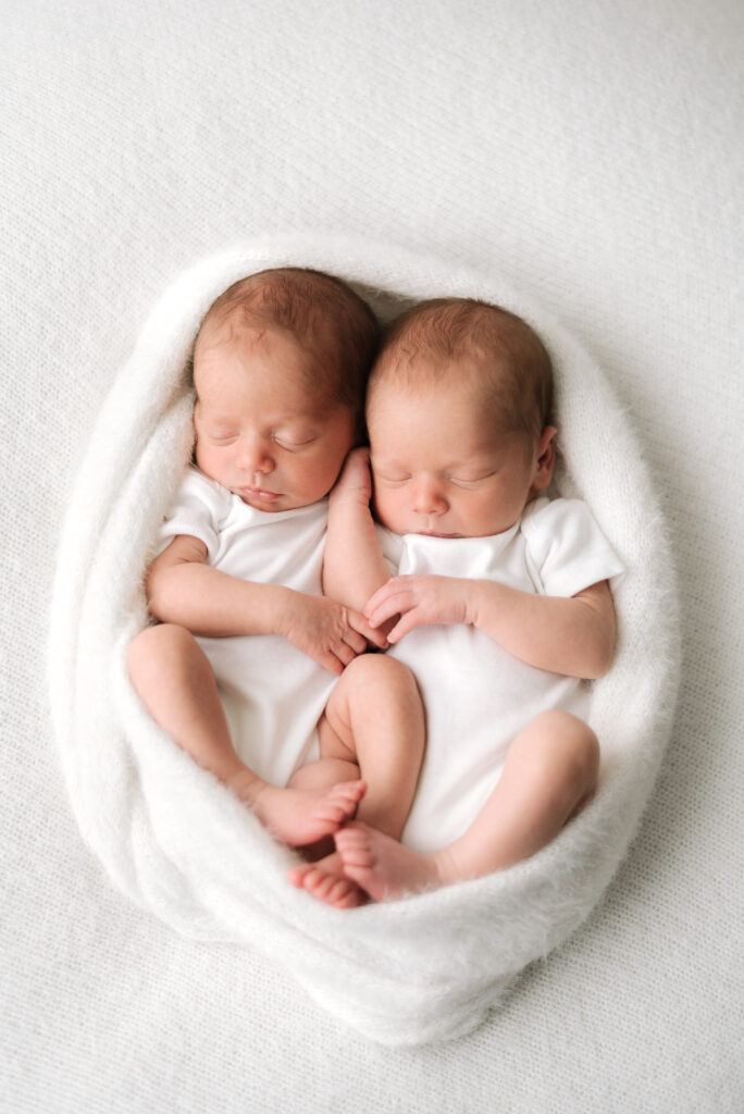 Twins wrapped up in a blanket at Newborn photoshoot in Billingshurst