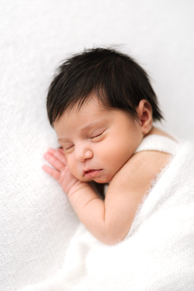 Baby girl sleeping on her hands at Billingshurst newborn photoshoot