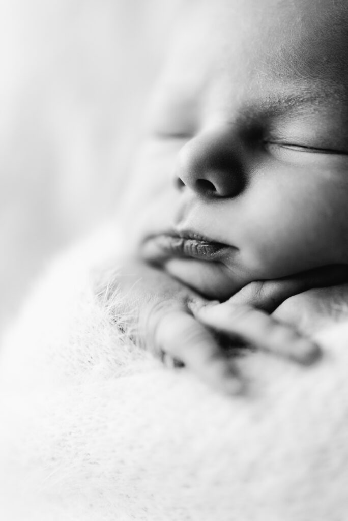 Close up of a newborn baby sleeping at West Sussex newborn photoshoot