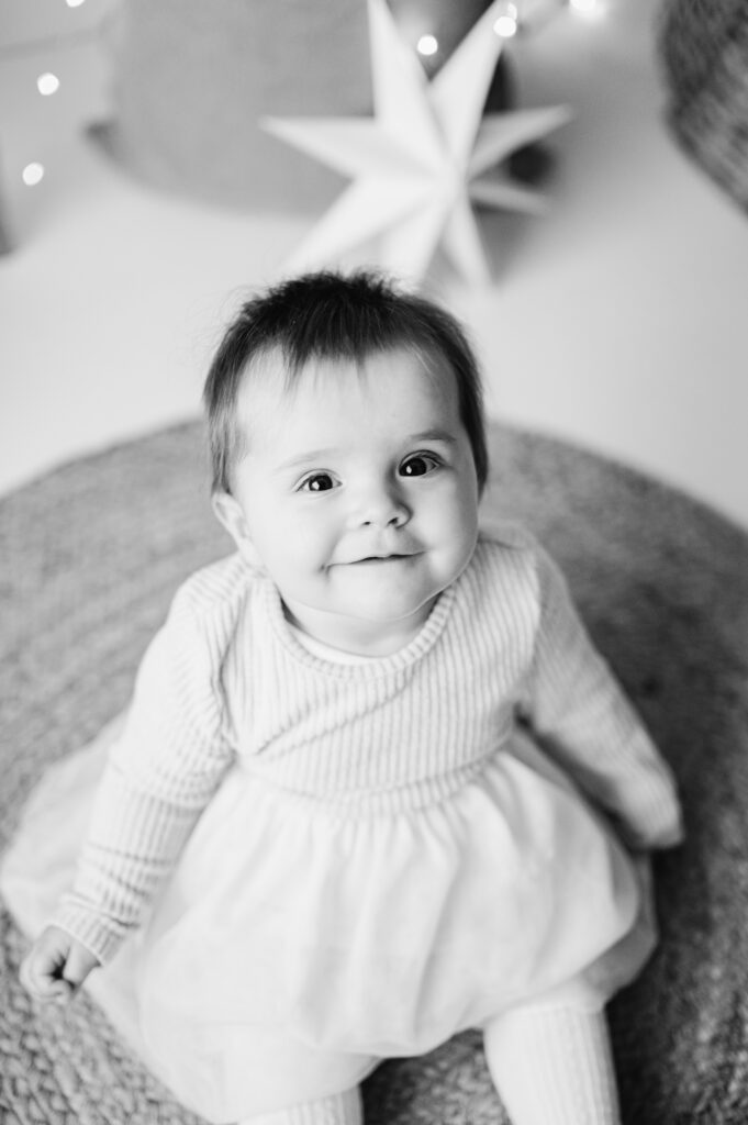 A baby girl smiling at West Sussex family christmas photoshoot