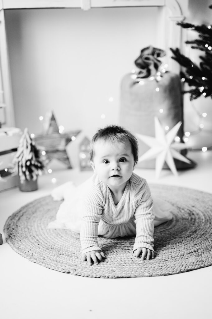 Baby girl laying on her tummy at a Christmas mini session