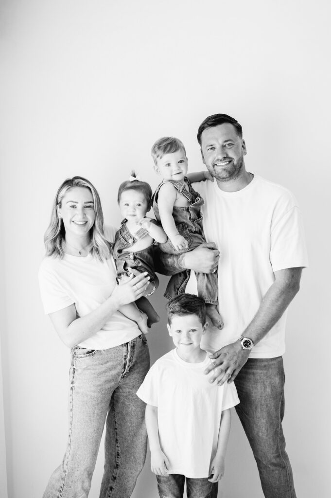 A family of 4 smiling at a Billingshurst photography studio