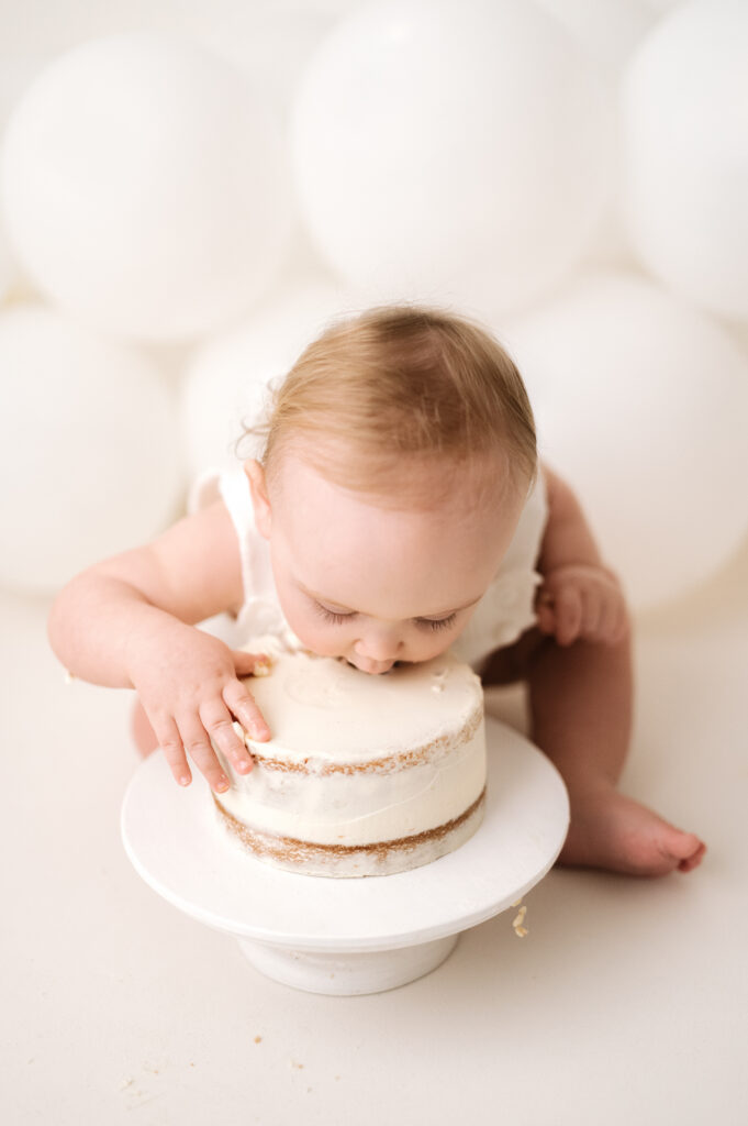 Little girl eating her cake at Horsham cake smash photoshoot